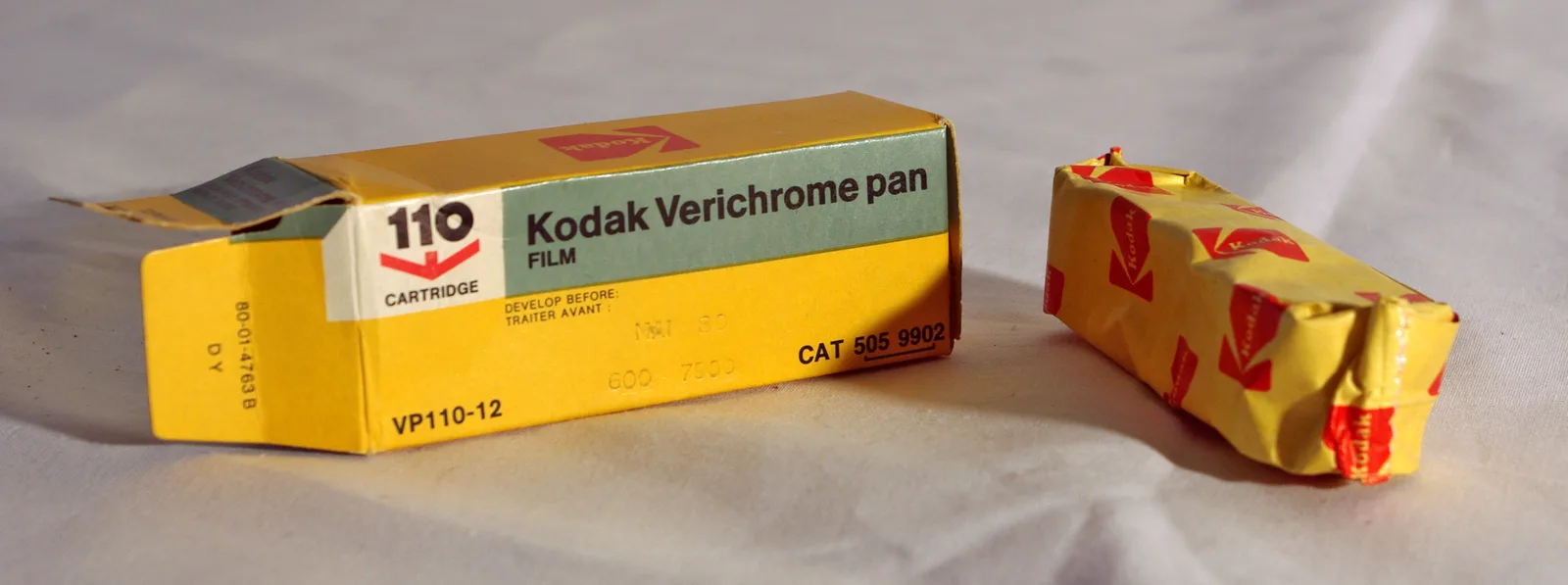 A 110 film cartridge photographed on a plain background, showing the drop-in plastic shell that made the format pocketable