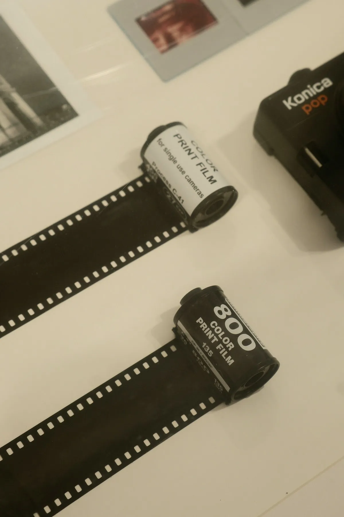 Film rolls and prints laid out on a table, a reminder of what analog photography offers